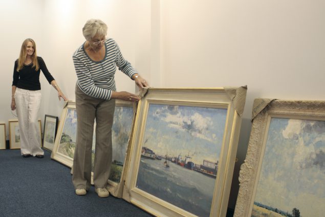Susan Marshall (left) and Margaret Carver prior to hanging the annual exhibition