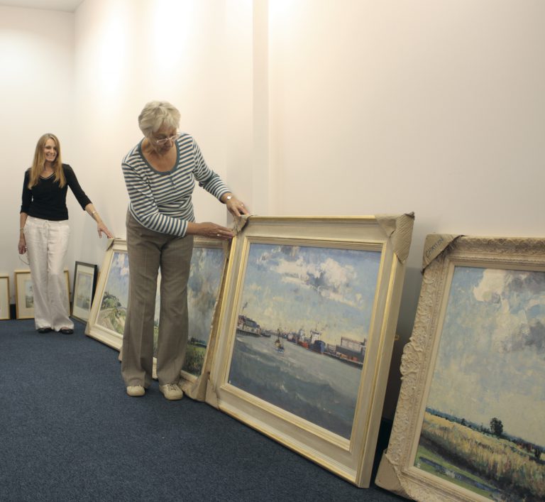 Susan Marshall (left) and Margaret Carver prior to hanging the annual exhibition